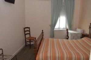 Postel nebo postele na pokoji v ubytování Hotel du Commerce