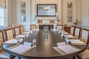 a large table in a room with a fireplace at De Vere Wokefield Estate in Reading +46 photos