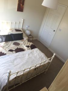 a bedroom with a bed and a white door at Family Home in Ossett in Ossett