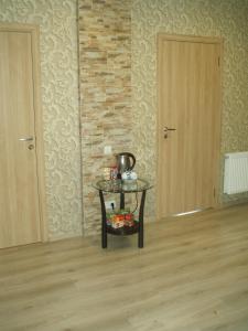 a room with two doors and a table with a kettle on it at Centra House in Rēzekne