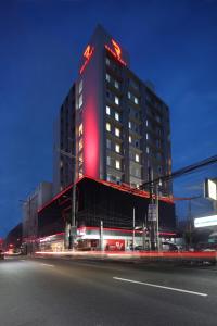 a building with a red sign on the side of it at Red Planet Cubao Aurora Boulevard in Manila