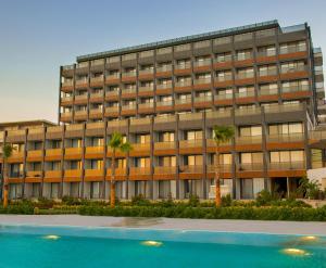 an office building with a pool in front of it at The Nowness Luxury Hotel & Spa in Cesme