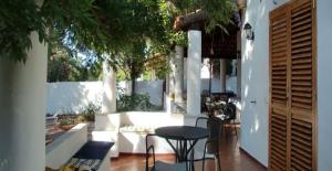 a patio with white furniture and a table and chairs at Villa il Glicine in Vulcano