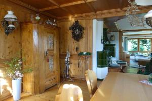 a dining room with a table and chairs and wood walls at Hollhouse - Bed & Breakfast in Hinterzarten