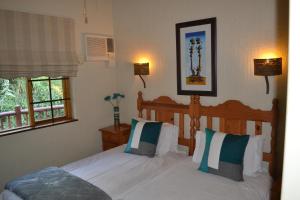 Postel nebo postele na pokoji v ubytování Kruger Park Lodge - Golf Safari SA