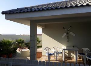 a patio with chairs and a table on a roof at Diana's Apartment in Swakopmund