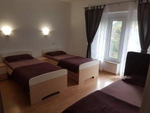 a room with two beds and a window at KEI apartment in Portorož