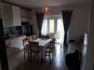 a kitchen and dining room with a table and chairs at KEI apartment in Portorož