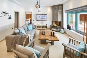 a living room with a couch and a table at Almyriki Beach Villa in Monolithos