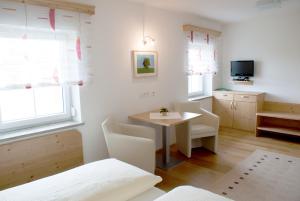 a room with a table and chairs and a tv at Landhaus Essl in Dietach