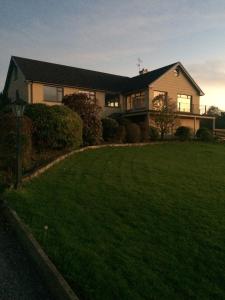 
a house is shown with a view of the grass at La Mirage B&B in Bantry
