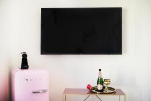 a flat screen tv hanging on a wall with a table at Victoria Hotel in Düsseldorf