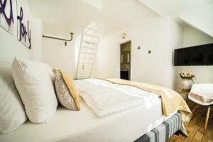 a bedroom with a white bed with pillows at Victoria Altstadt Hotel in Düsseldorf