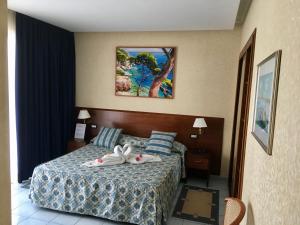 Postel nebo postele na pokoji v ubytování Grand Hotel L'Approdo