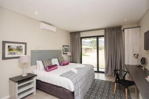 Ένα ή περισσότερα κρεβάτια σε δωμάτιο στο Du Kloof Lodge +63 φωτογραφίες