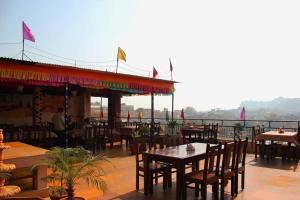 a restaurant with a table and chairs on a balcony at Tripli Hotels Prithvi Palace in Jaisalmer