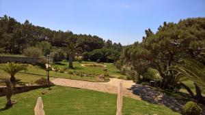 a view of a park with trees and grass at Quinta do Cabo Guesthouse in Sintra