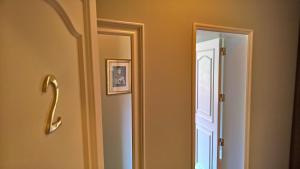 a bathroom door with a mirror next to it at Quinta do Cabo Guesthouse in Sintra