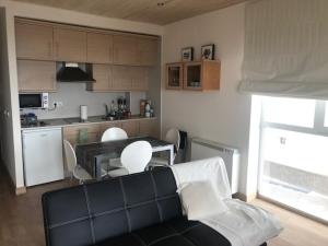 sala de estar con sofá y cocina en Apartamento de Lujo con Vistas Panorámicas, en Sierra Nevada