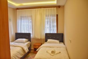 a small room with two beds and a window at Badul Apart in Uzungöl