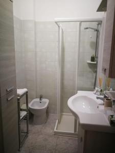 a bathroom with a shower and a toilet and a sink at Cabà Holiday Bardolino Gritti in Bardolino
