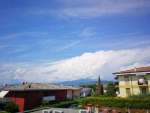 a view of a city with mountains in the background at Cabà Holiday Bardolino Gritti in Bardolino