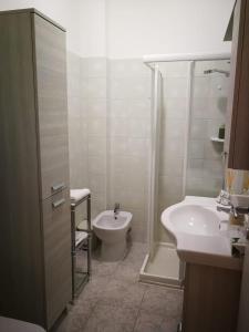 a bathroom with a shower and a toilet and a sink at Cabà Holiday Bardolino Gritti in Bardolino