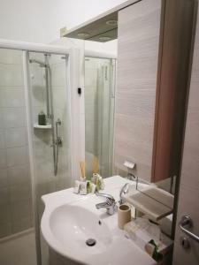 a bathroom with a sink and a shower and a mirror at Cabà Holiday Bardolino Gritti in Bardolino +37 photos