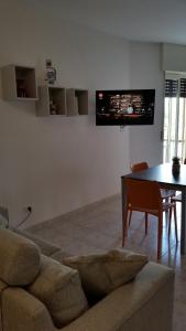 a living room with a couch and a table at Cabà Holiday Bardolino Gritti in Bardolino
