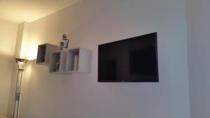 a living room with a tv and a lamp at Cabà Holiday Bardolino Gritti in Bardolino