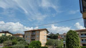 a group of apartment buildings with a blue sky at Cabà Holiday Bardolino Gritti in Bardolino
