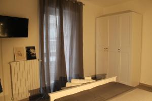 a living room with a window and a white cabinet at Casa Mirò in Polignano a Mare