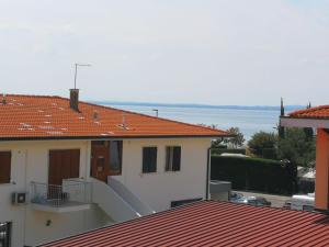 a view of a house with the ocean in the background at Cabà Holiday Bardolino Gritti in Bardolino