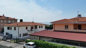 a white van parked in between two buildings at Cabà Holiday Bardolino Gritti in Bardolino