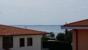 a view of the water from between two buildings at Cabà Holiday Bardolino Gritti in Bardolino