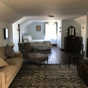 a living room with a couch and a bed at Riverboat Bed & Breakfast in Natchez