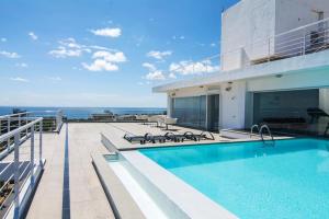 a swimming pool on the deck of a building at Lincoln Suite in Santo Domingo