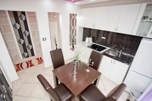 a kitchen with a table and chairs in a room at Apartments Admiral in Perast