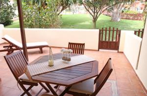 a wooden table and chairs on a patio at Los Balconcitos 51 in Los Cancajos