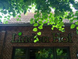 a sign on top of a brick building at Boutique Hotel Lindenhof, Bed & Breakfast in Aurich