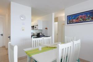 a kitchen and dining room with a table and chairs at Chakas Cove 94 in Ballito
