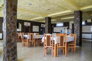 a dining room with wooden tables and chairs at Pensiunea Nicol in Valea Iasului