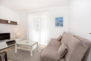 a living room with a couch and a table at Apartments Alenka by the sea in Labin