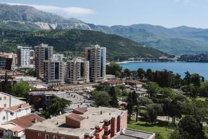 a city with buildings and a body of water and mountains at Arka Budva in Budva +44 photos