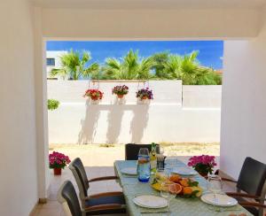 a dining table with a view of the beach at Katerina in Ayia Napa