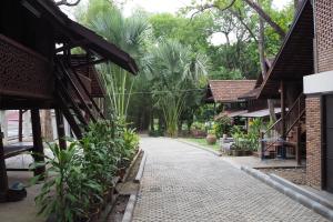 a walkway through a courtyard of a house at Insight Hostel in Chiang Mai
