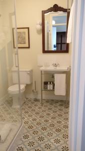 a bathroom with a toilet and a sink and a mirror at Pousada Vila Óbidos in Óbidos +31 photos