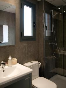 e bagno con servizi igienici, lavandino e doccia. di SG Costa Barcelona Apartments a Castelldefels