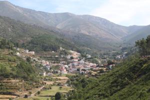 a village in a valley in the mountains at Casa da Ponte in Alvoco da Serra