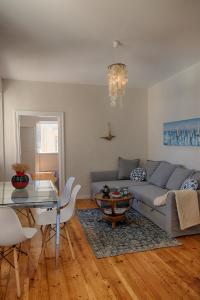 a living room with a couch and a glass table at Serene Sea View Apartment in Corfu Old Town in Corfu